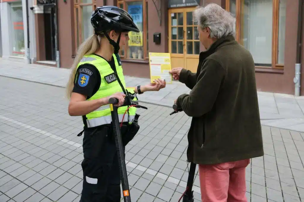 policijos pareigune vyras elektriniai paspirtukai