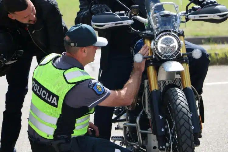policijos pareigunas tikrina motocikla