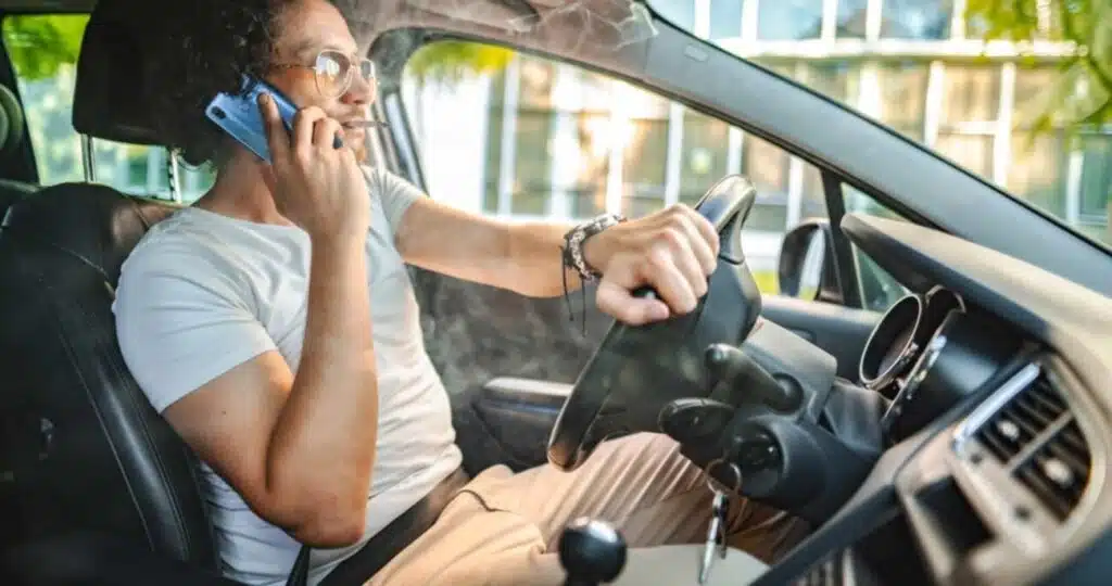 10 automobilių vairuotojų nuodėmių vairuotojas ruko cigarete ir naudojasi mobiliuoju telefonu vairuodamas automobili