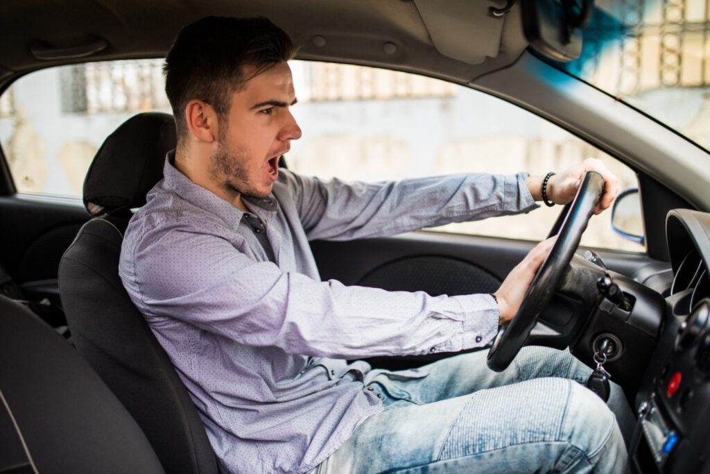 piktas agresyvus automobilio vairuotojas vyras spaudzia garso signala ant automobilio vairo