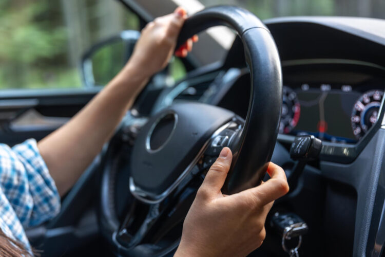 Rankos ant šiuolaikinio automobilio vairo važiuojant vairavimo kontrolė ir pasitikėjimas kelyje